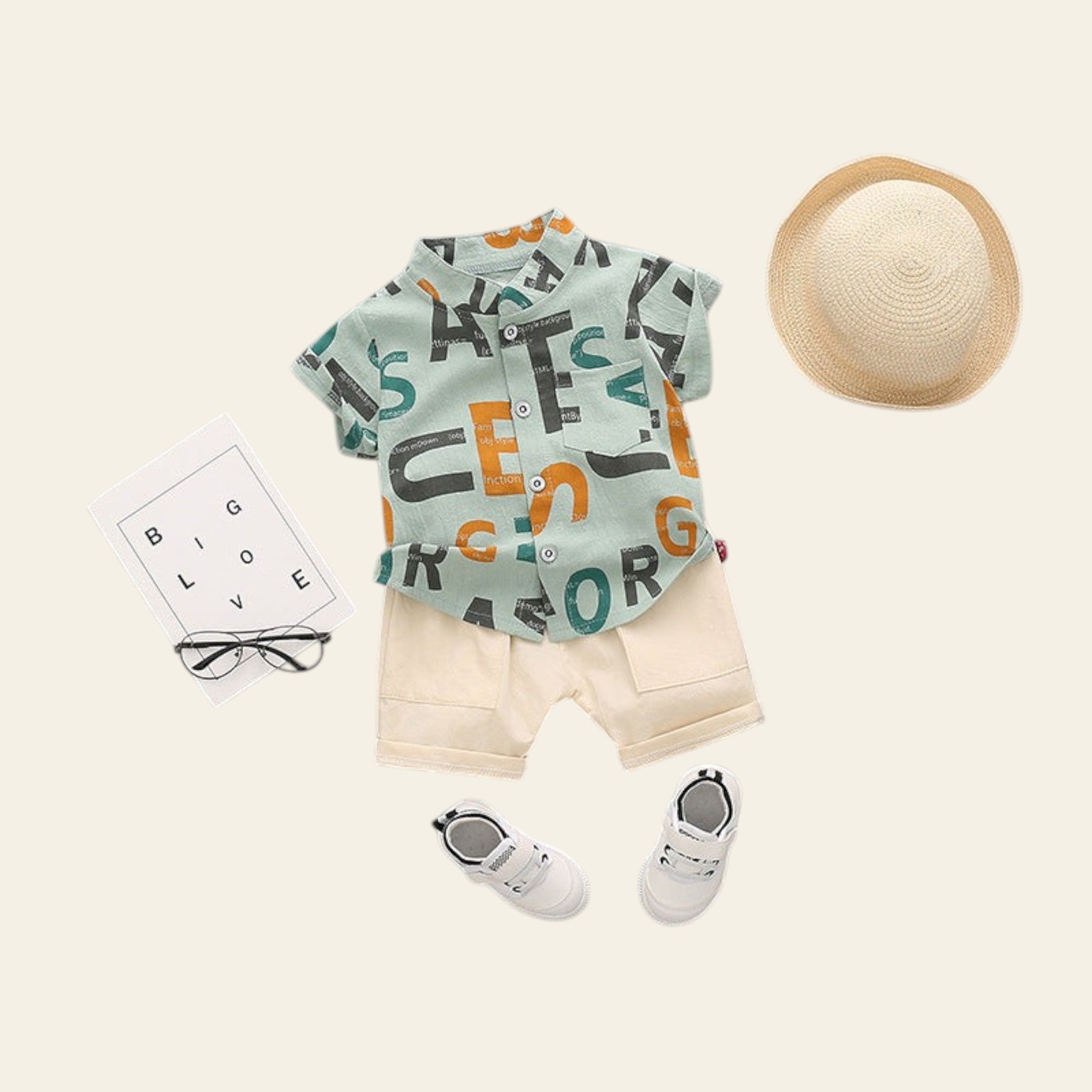 Children's outfit with a shirt, shorts, shoes, and a hat on a gray background