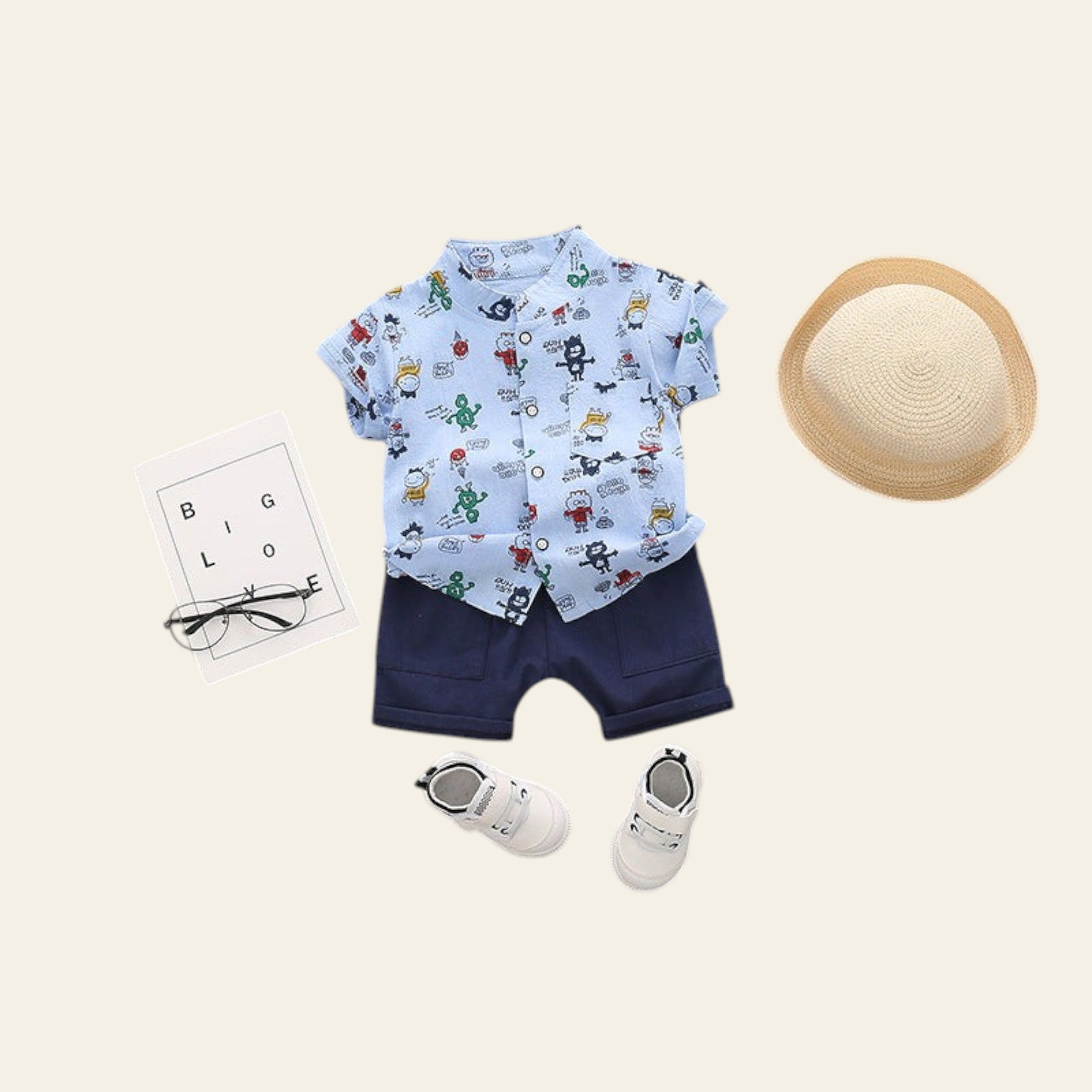 Children's outfit with shirt, shorts, shoes, and hat on a gray background