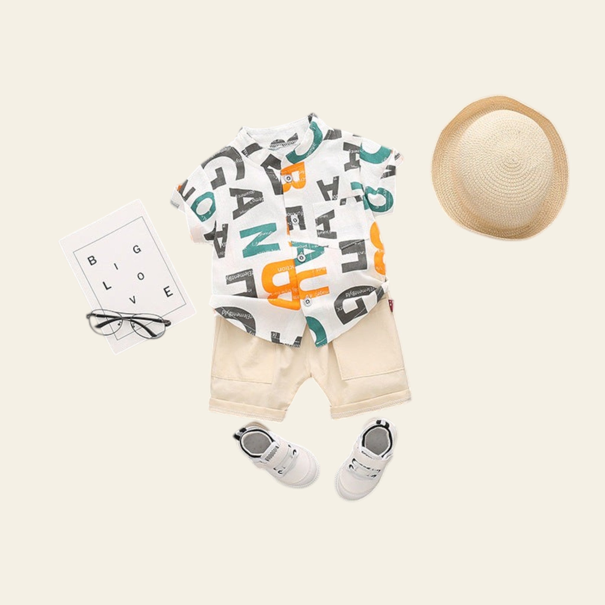 Children's outfit with a t-shirt, shorts, shoes, and a hat on a gray background