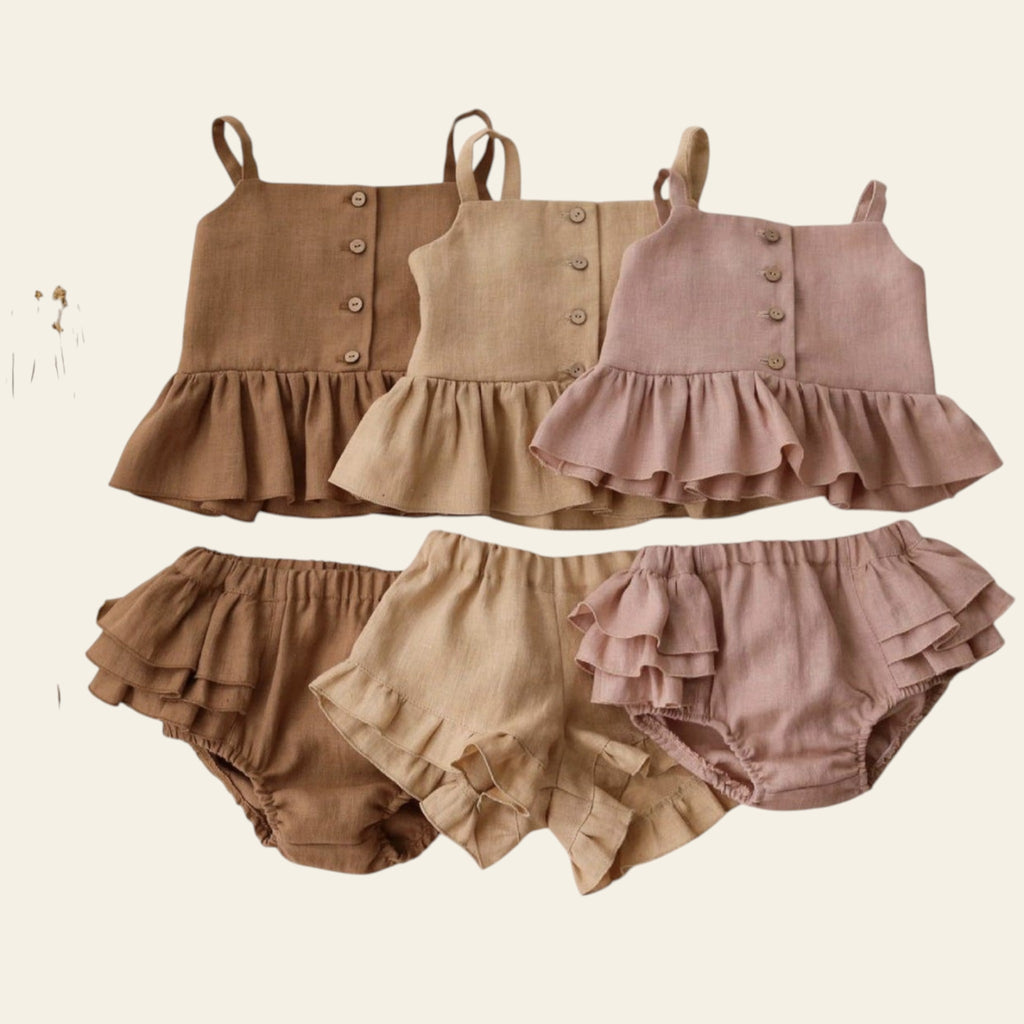 Set of children's ruffled top and bloomers in brown, beige, and pink on a white background.