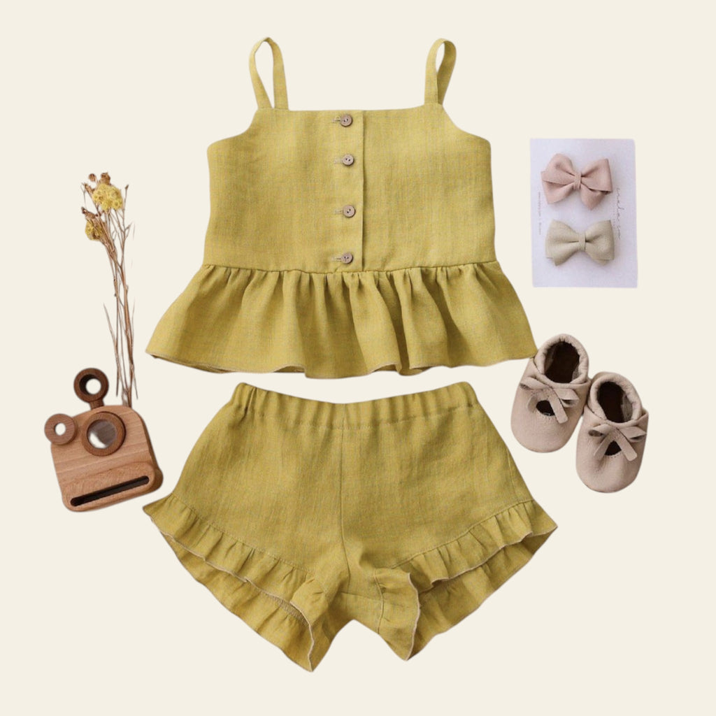 Yellow children's outfit with matching shoes and accessories on a light background