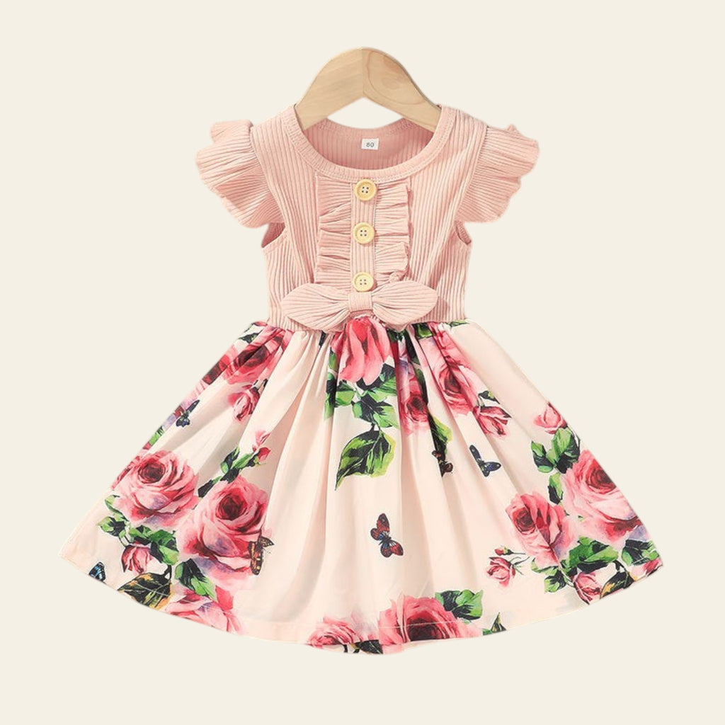 Floral dress with ruffled sleeves on a hanger against a neutral background