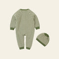 Green and white patterned baby onesie and hat set on a white background