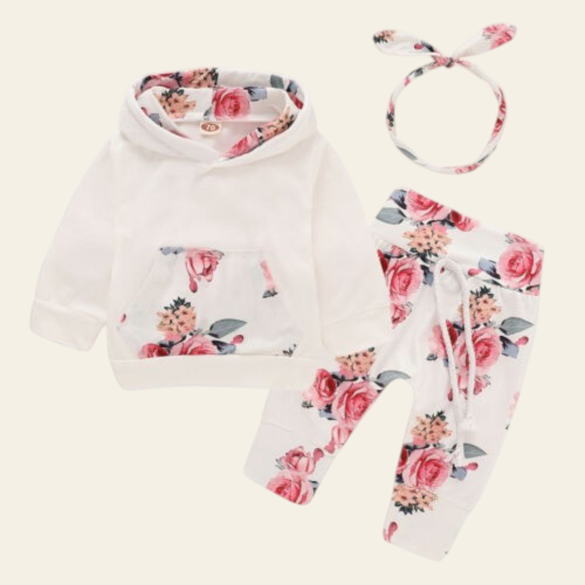 Baby outfit set with floral hoodie, pants, and headband on a white background