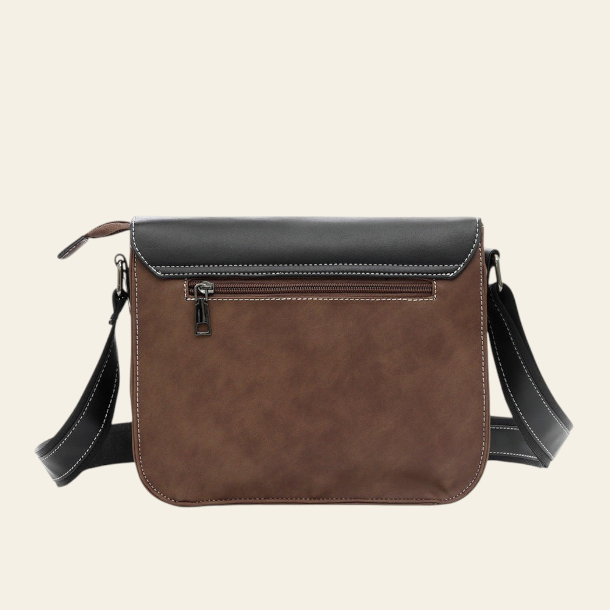 Brown leather crossbody bag with black accents on a white background