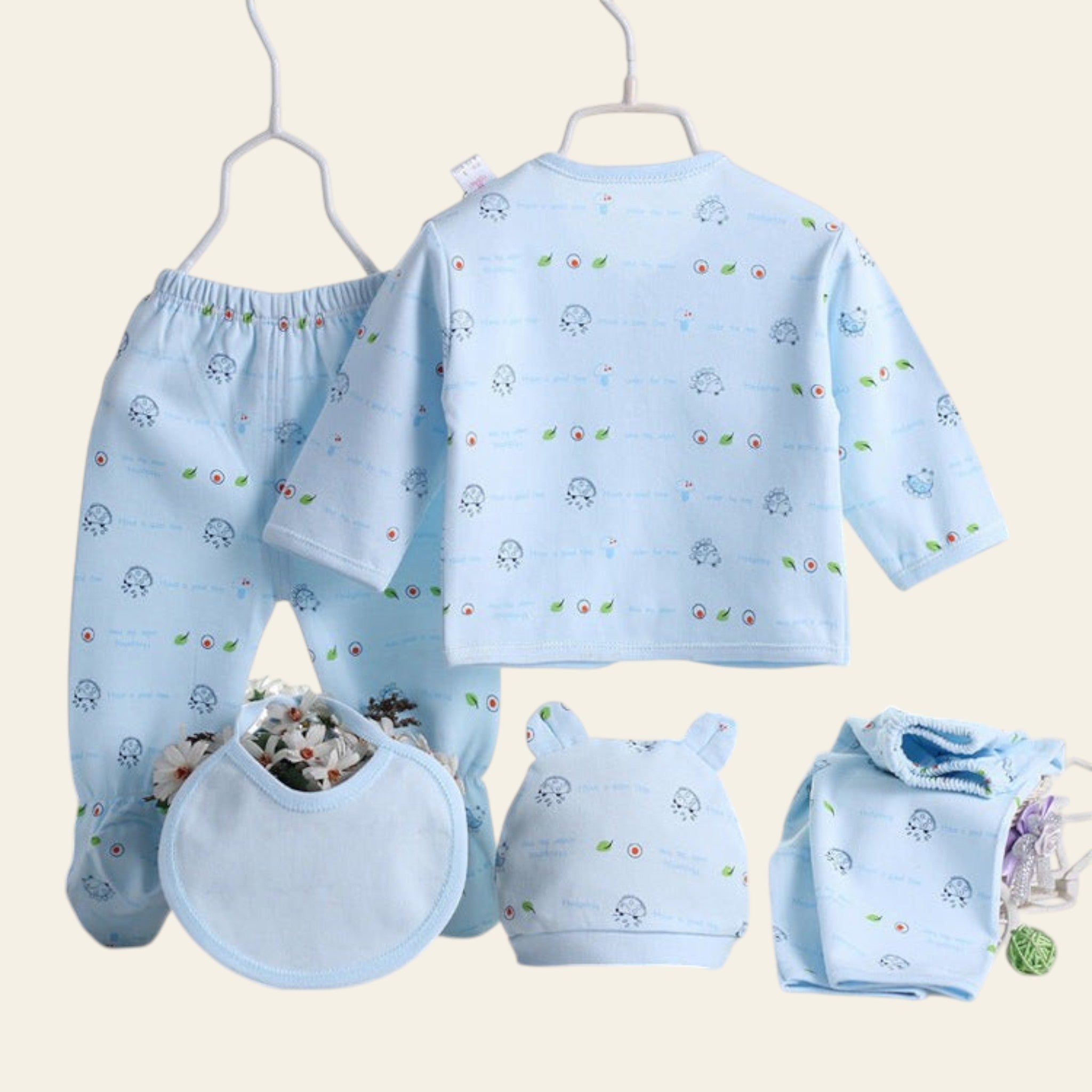 Baby blue outfit set with long-sleeve shirt, pants, bib, hat, and diaper on a white background.