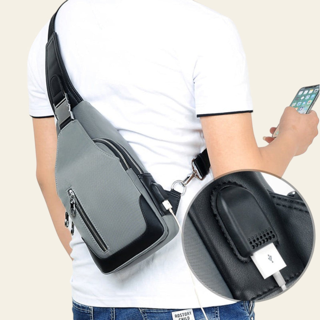 Person wearing a gray crossbody bag with a close-up of the USB charging port.