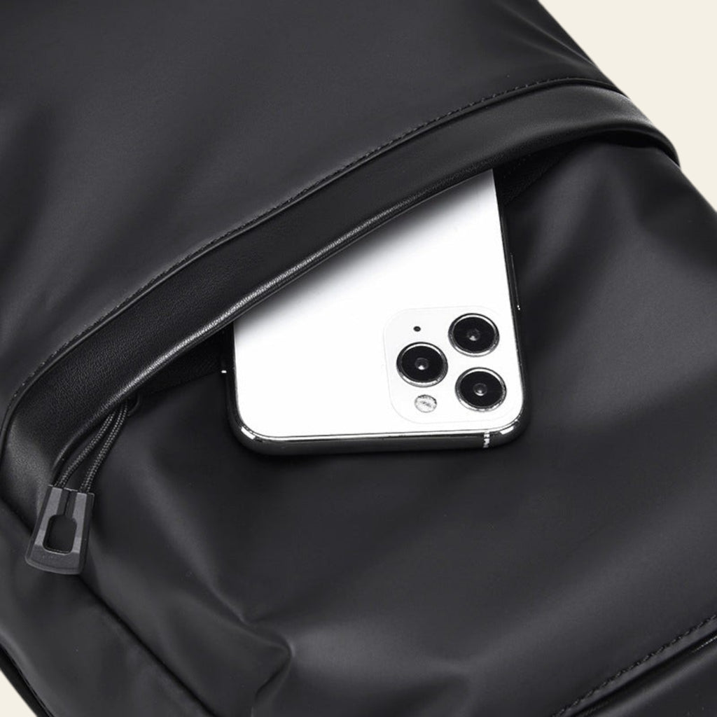 Smartphone peeking out from a black jacket pocket