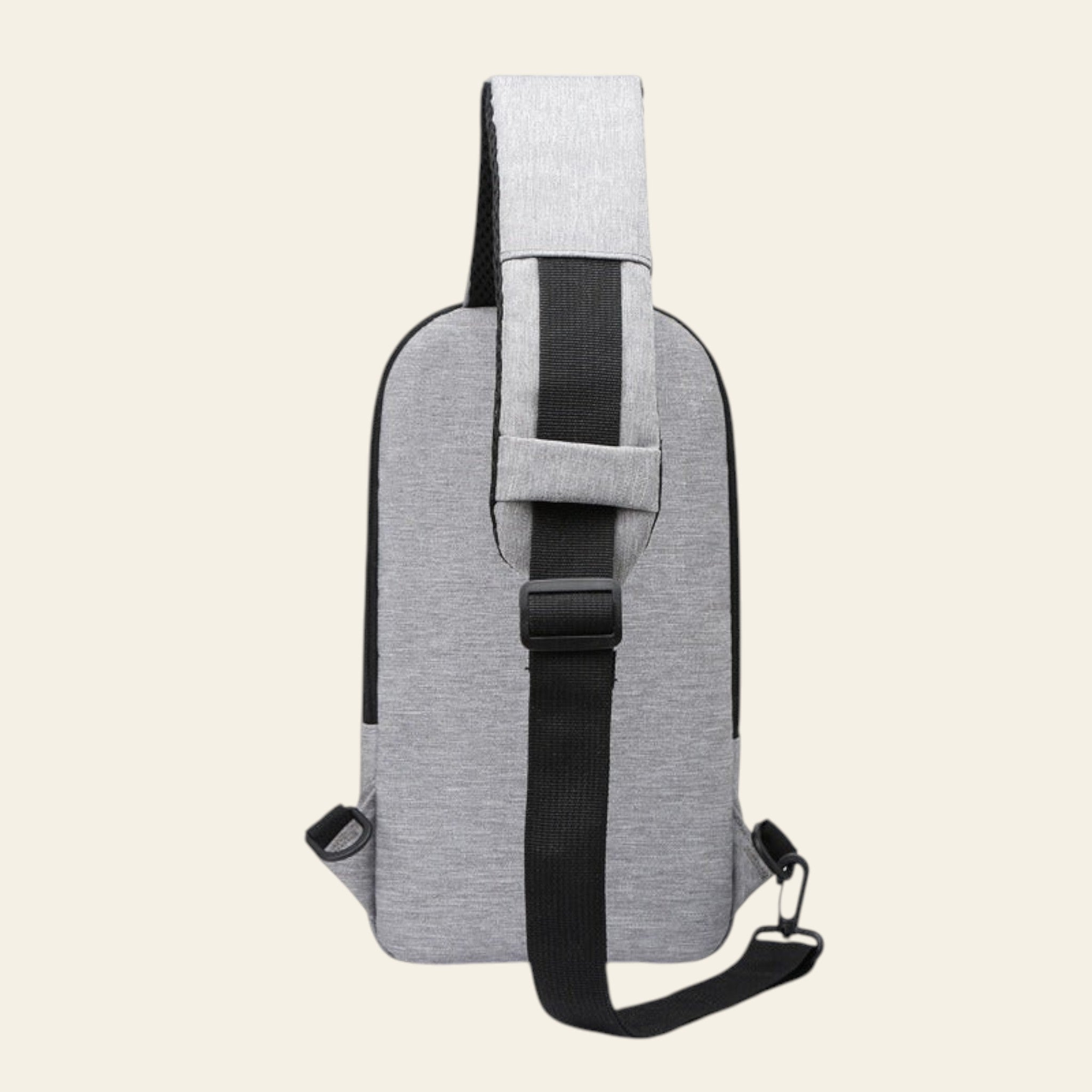 Gray shoulder bag with a black strap on a white background