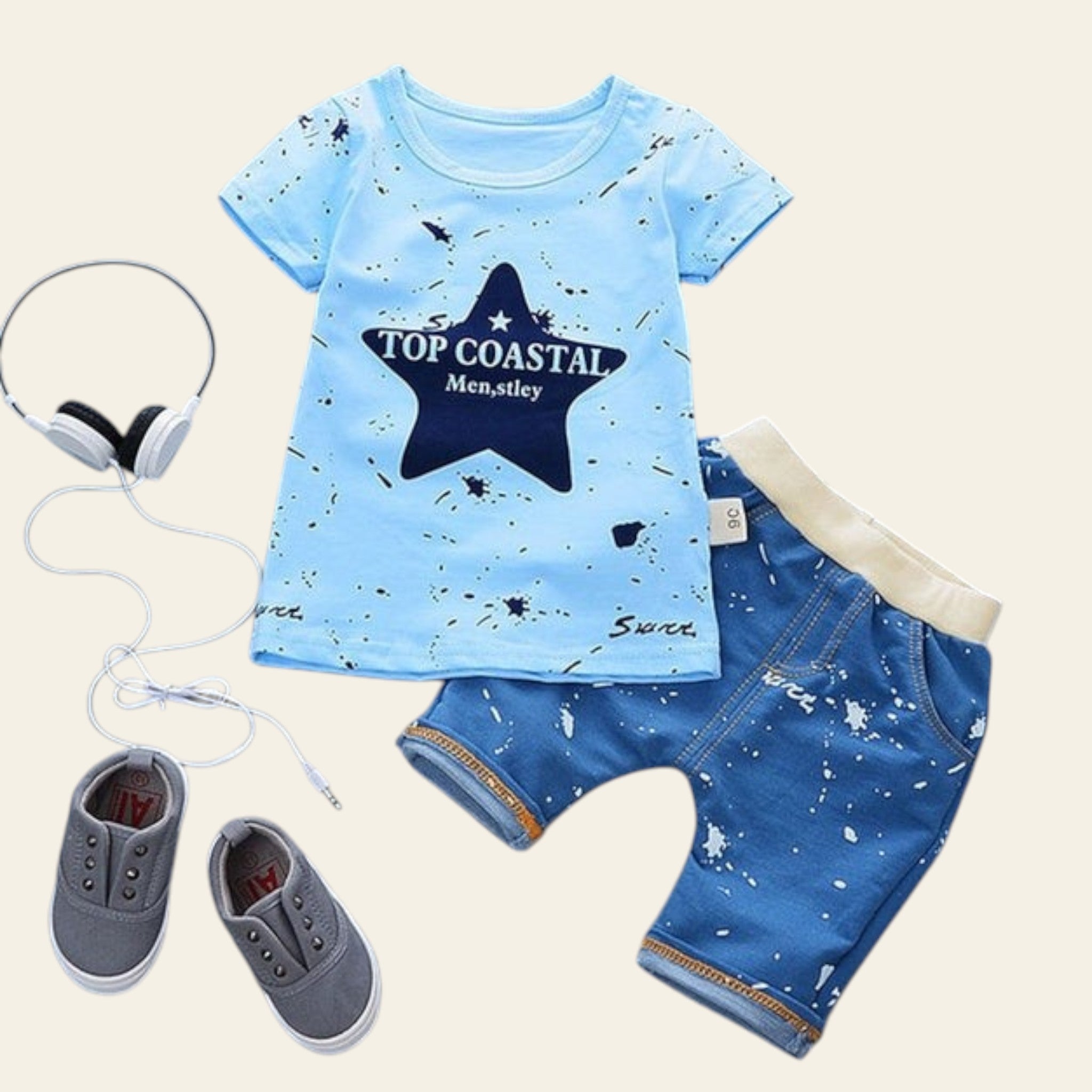 Children's blue t-shirt and shorts set with headphones and shoes on a gray background