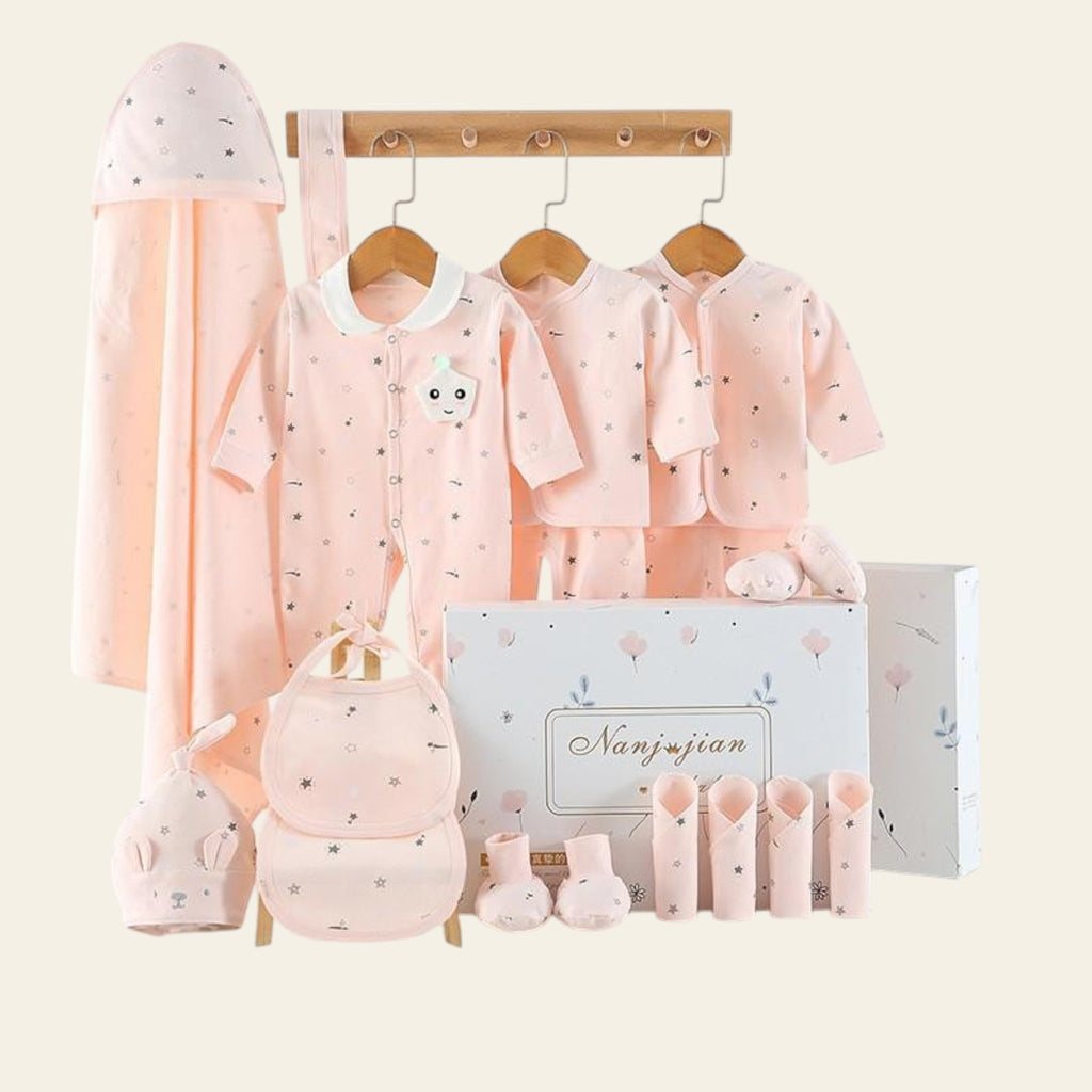 Baby clothing set with pink outfits, hats, and bags on a white background
