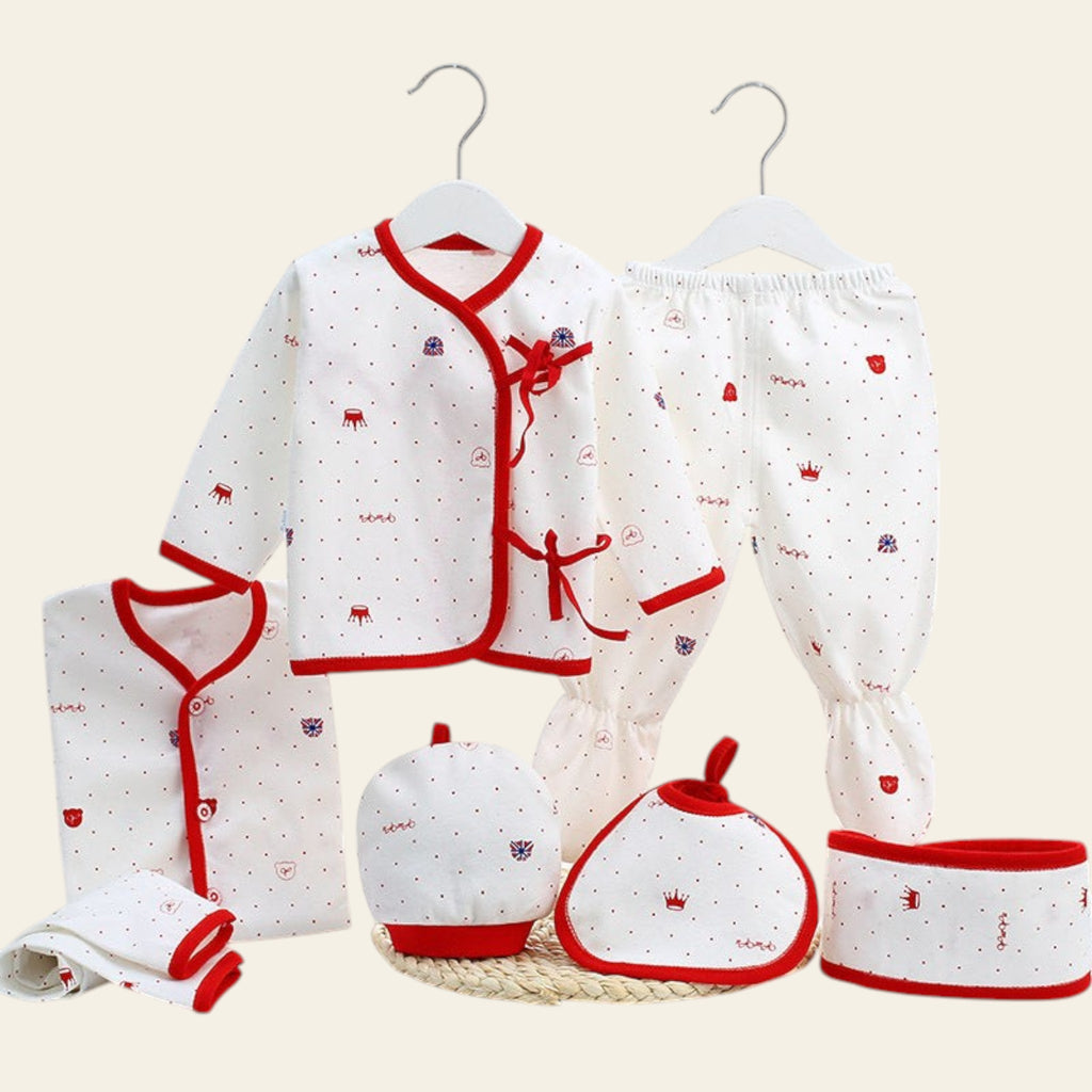 Baby clothing set with red and white patterns on a white surface.
