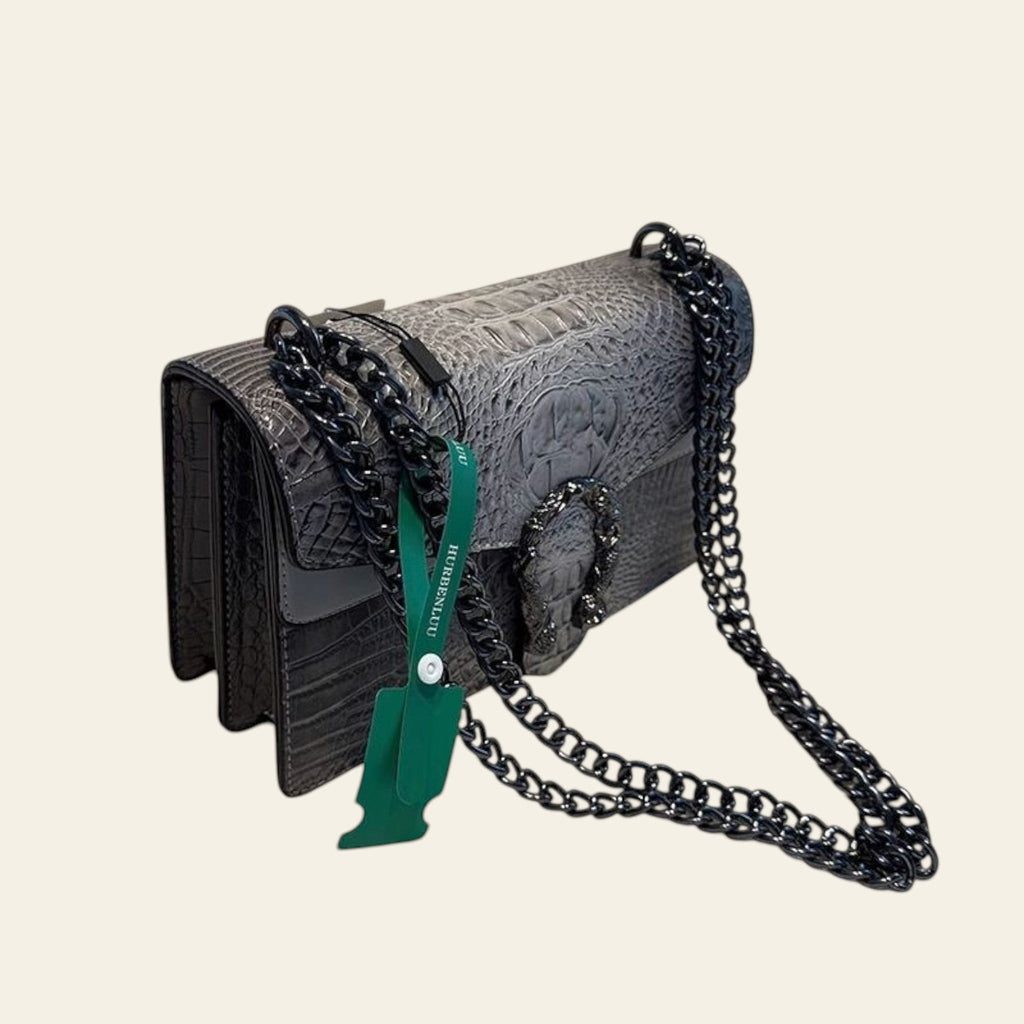 Gray textured handbag with black chain strap on a white surface, with 'HURBENLIU' branding visible.