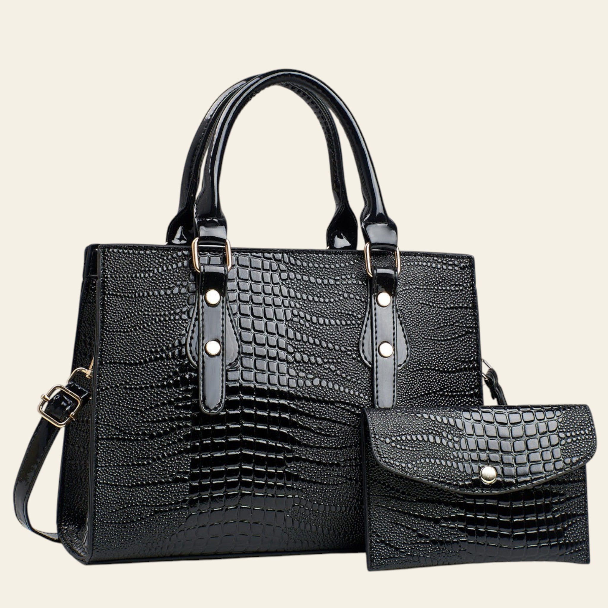 Black crocodile-patterned handbag with matching pouch on a light gray background