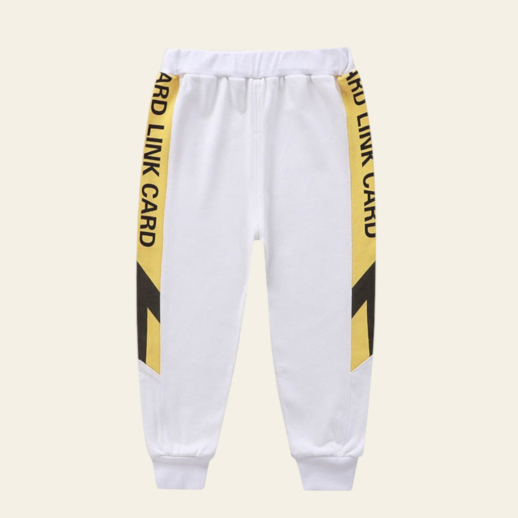 White sweatpants with yellow and black striped side panels on a white background