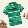 Green polo shirt with white stripes on a gray surface