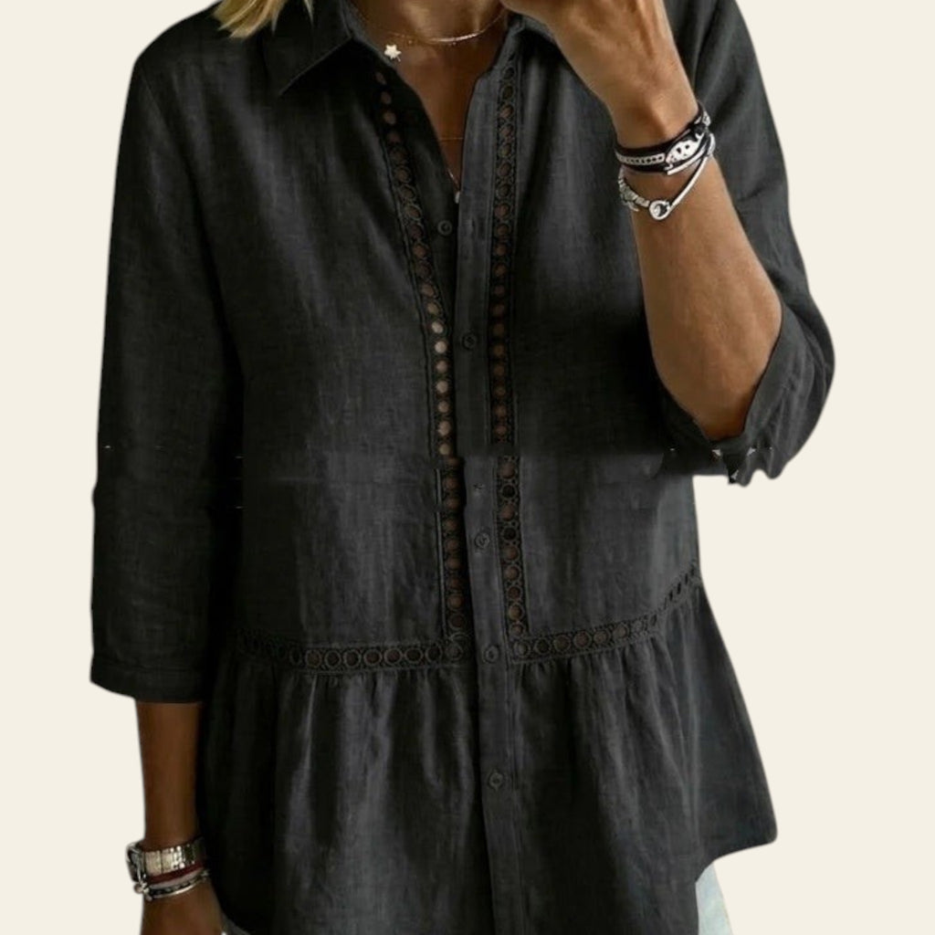 Person wearing a dark denim shirt in a living room setting
