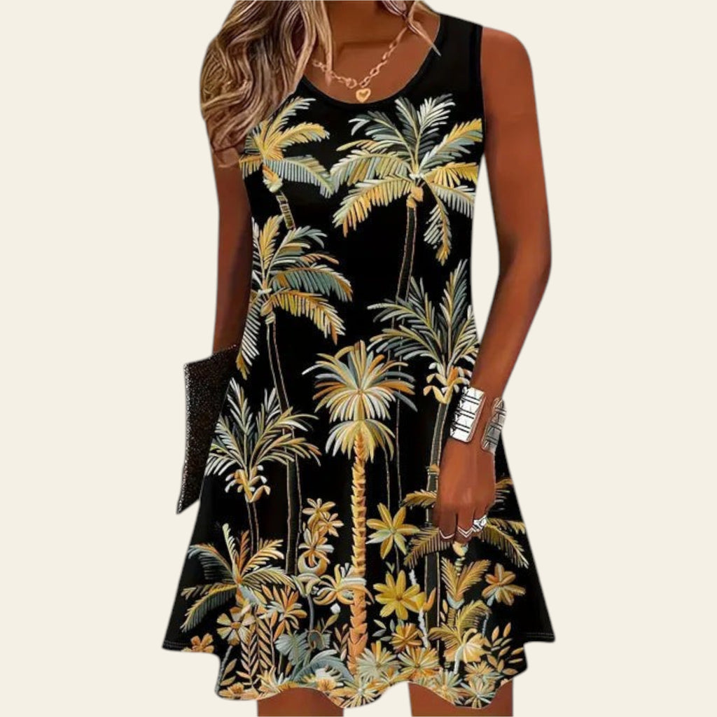 woman wearing a black sleeveless dress with tropical palm leaf floral print