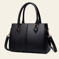 Black handbag with gold accents on a white background