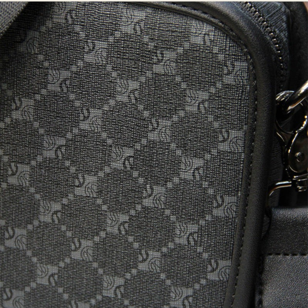 Close-up of a textured black bag with a patterned surface