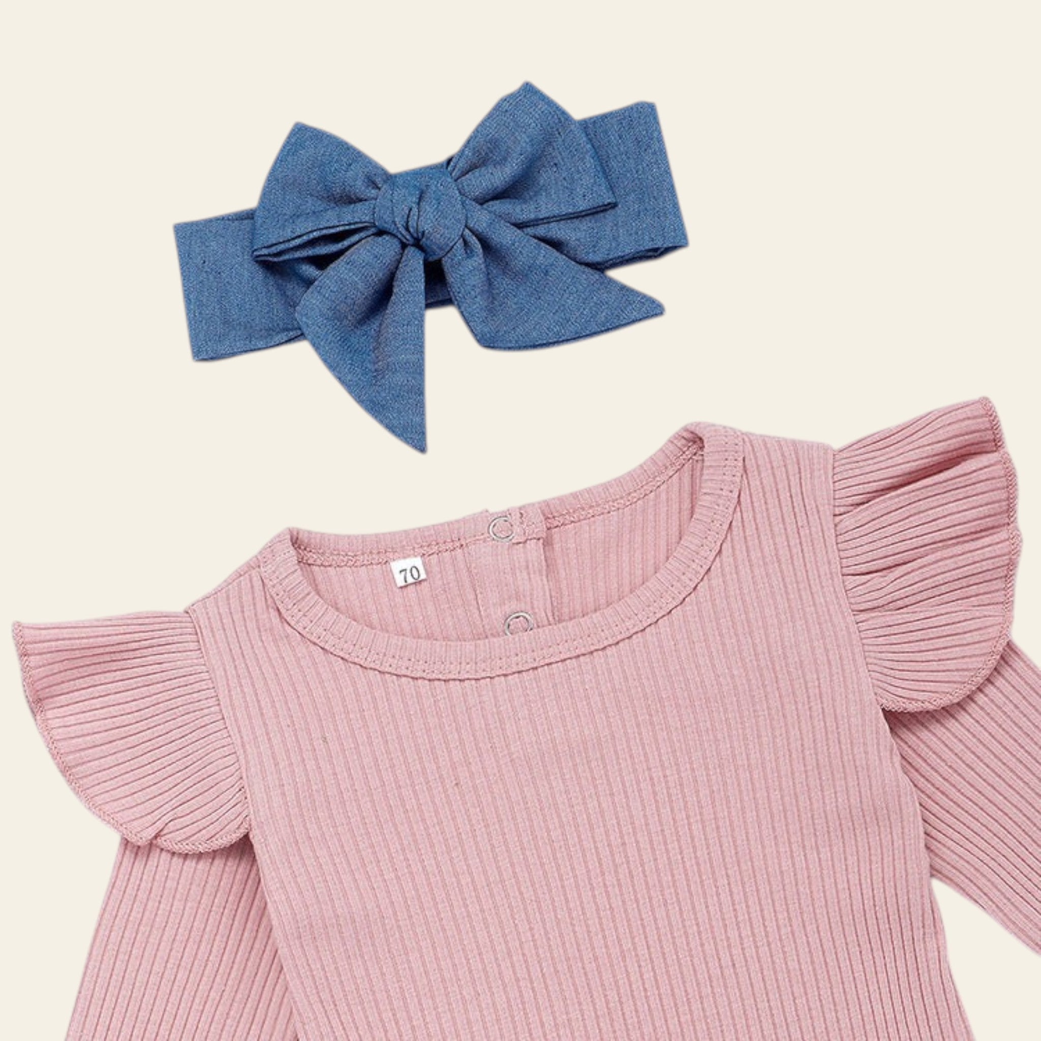 Pink ribbed top with ruffled sleeves and a blue denim bow on a white background