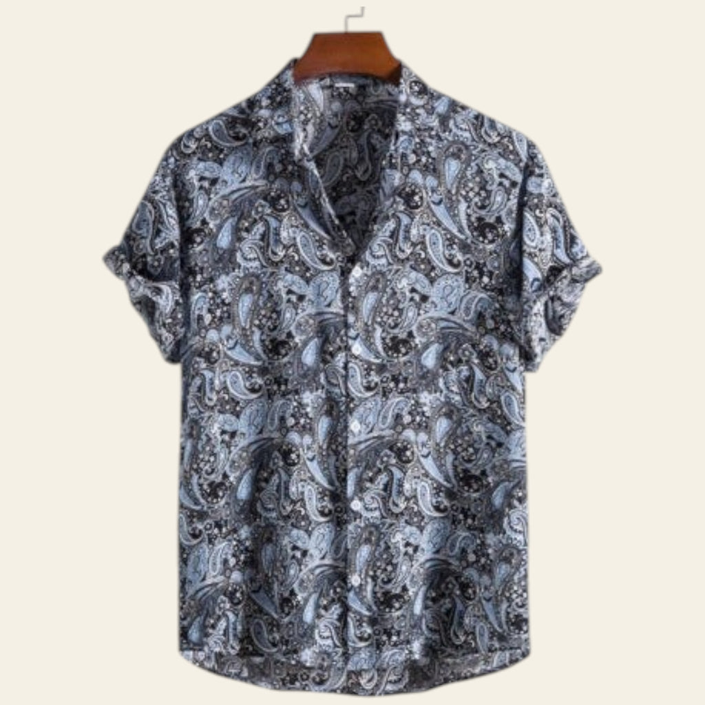 Short-sleeve shirt with paisley pattern on a hanger against a white background