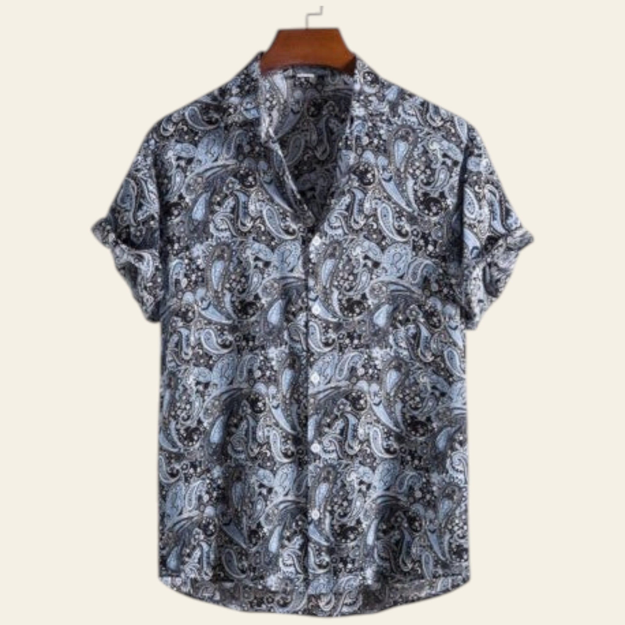 Short-sleeve shirt with paisley pattern on a hanger against a white background