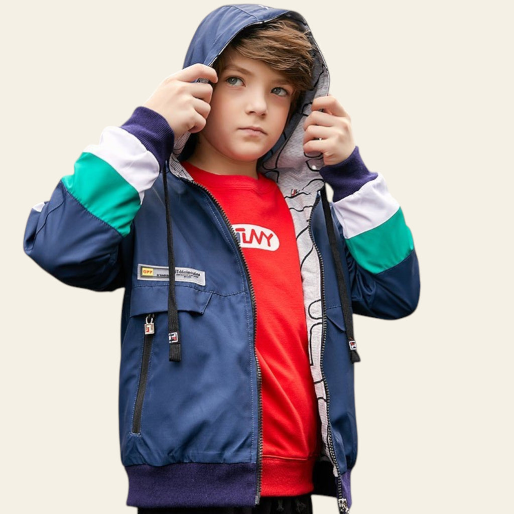 Child wearing a colorful jacket with a cityscape background