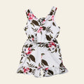 Floral romper on a wooden surface with decorative elements