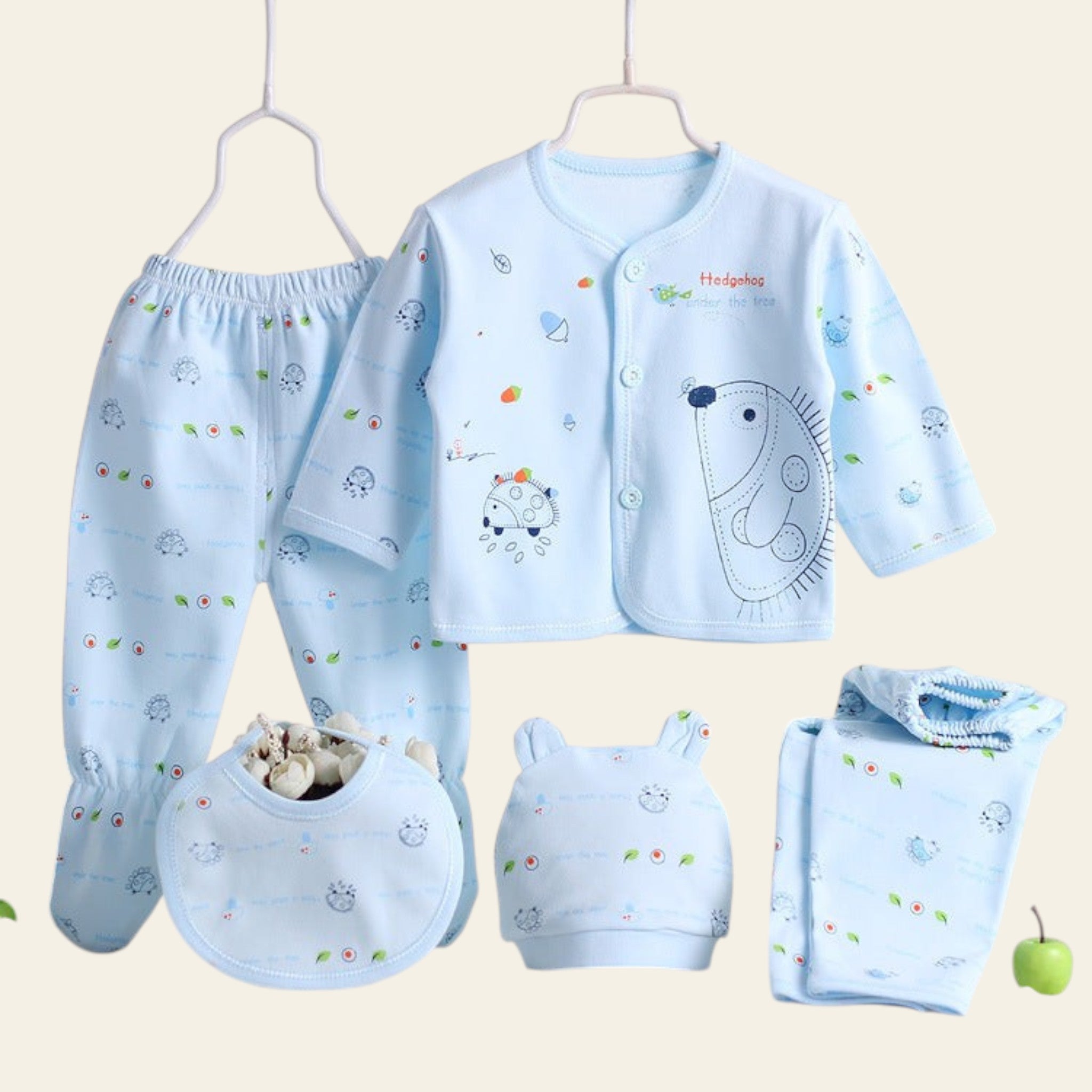 Baby clothing set with a blue shirt, pants, bib, and booties on a white surface.
