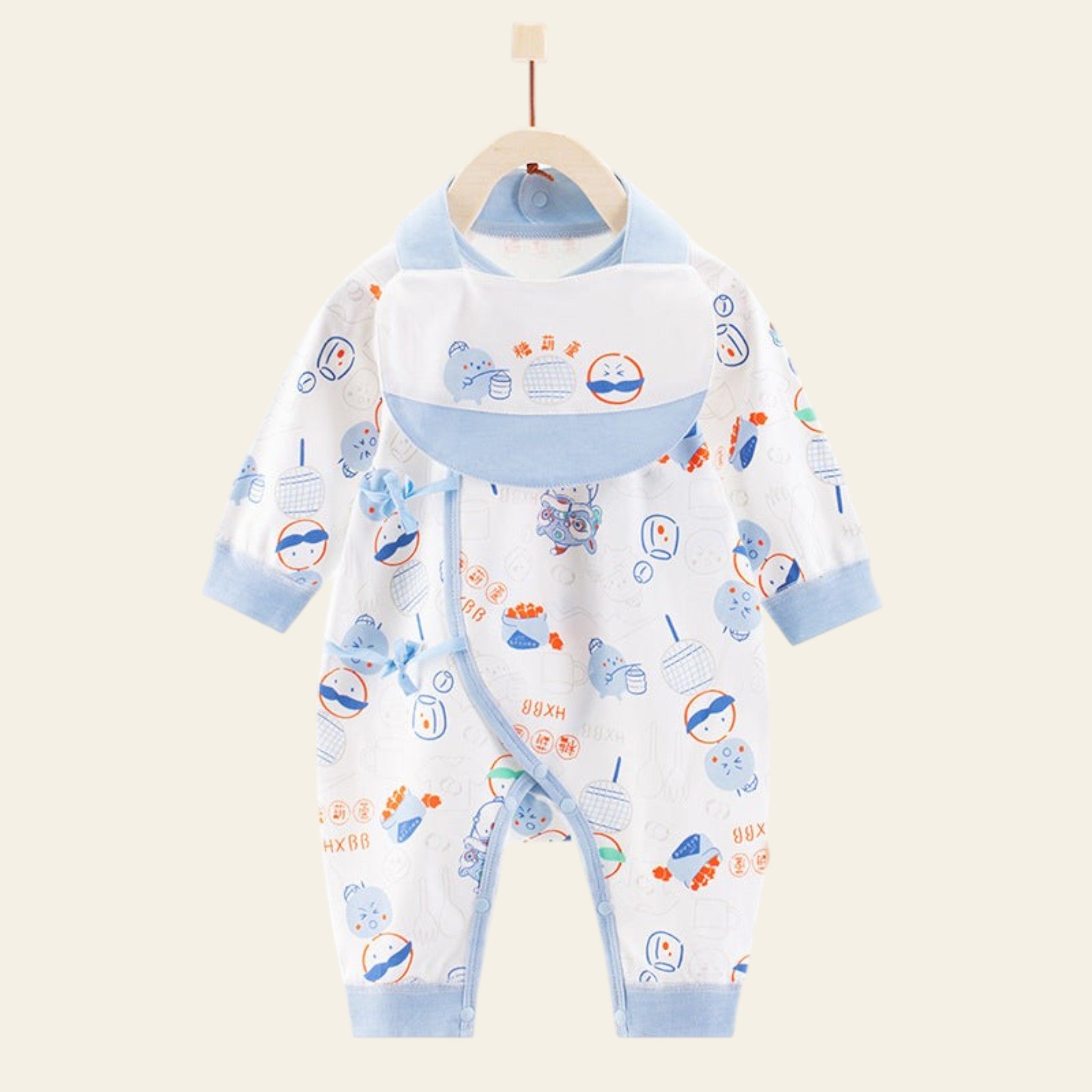 Baby outfit with bib and romper on a hanger against a white background