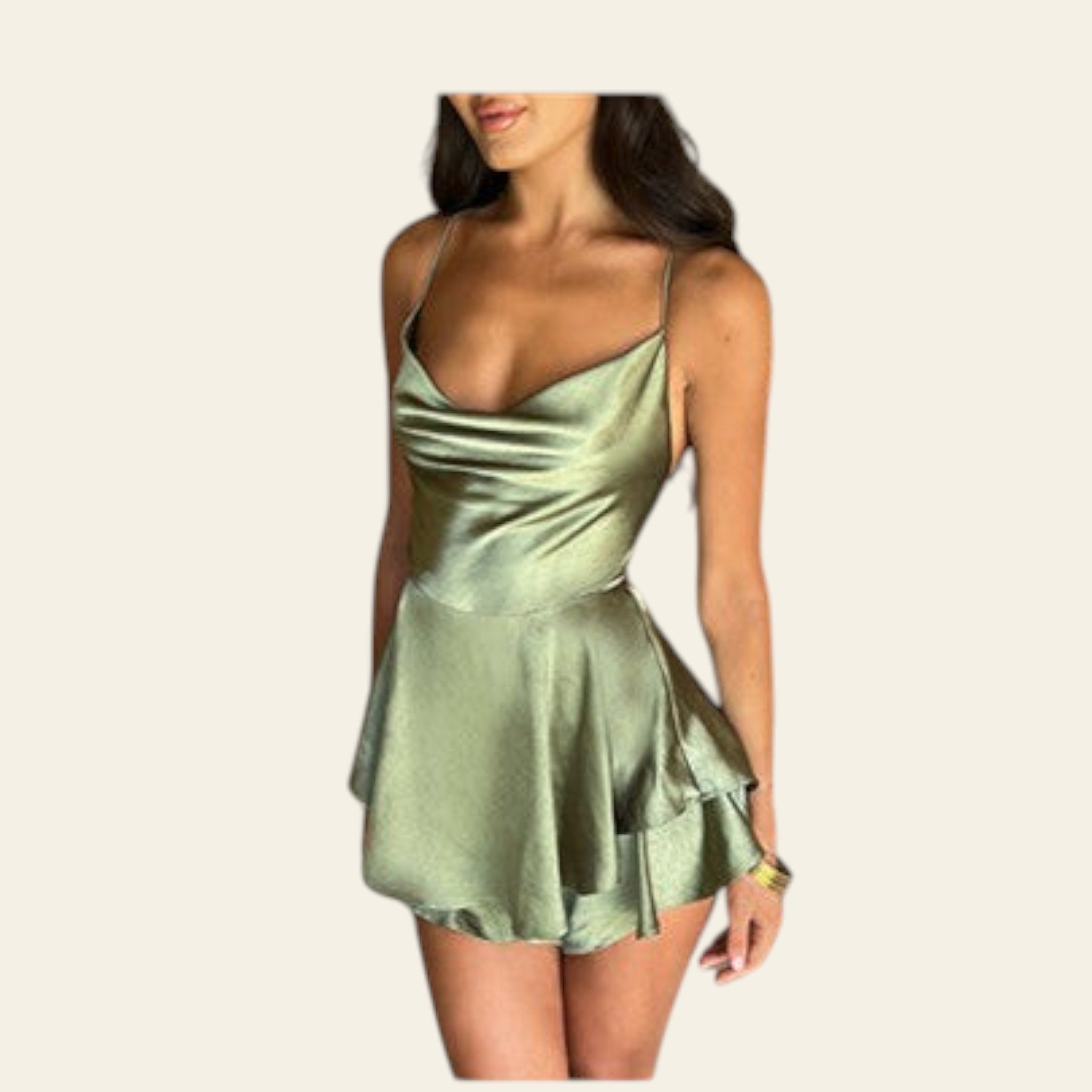 Woman wearing a green dress with a diamond bracelet on a white background