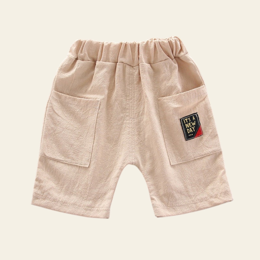 Beige shorts with a patch on a gray background