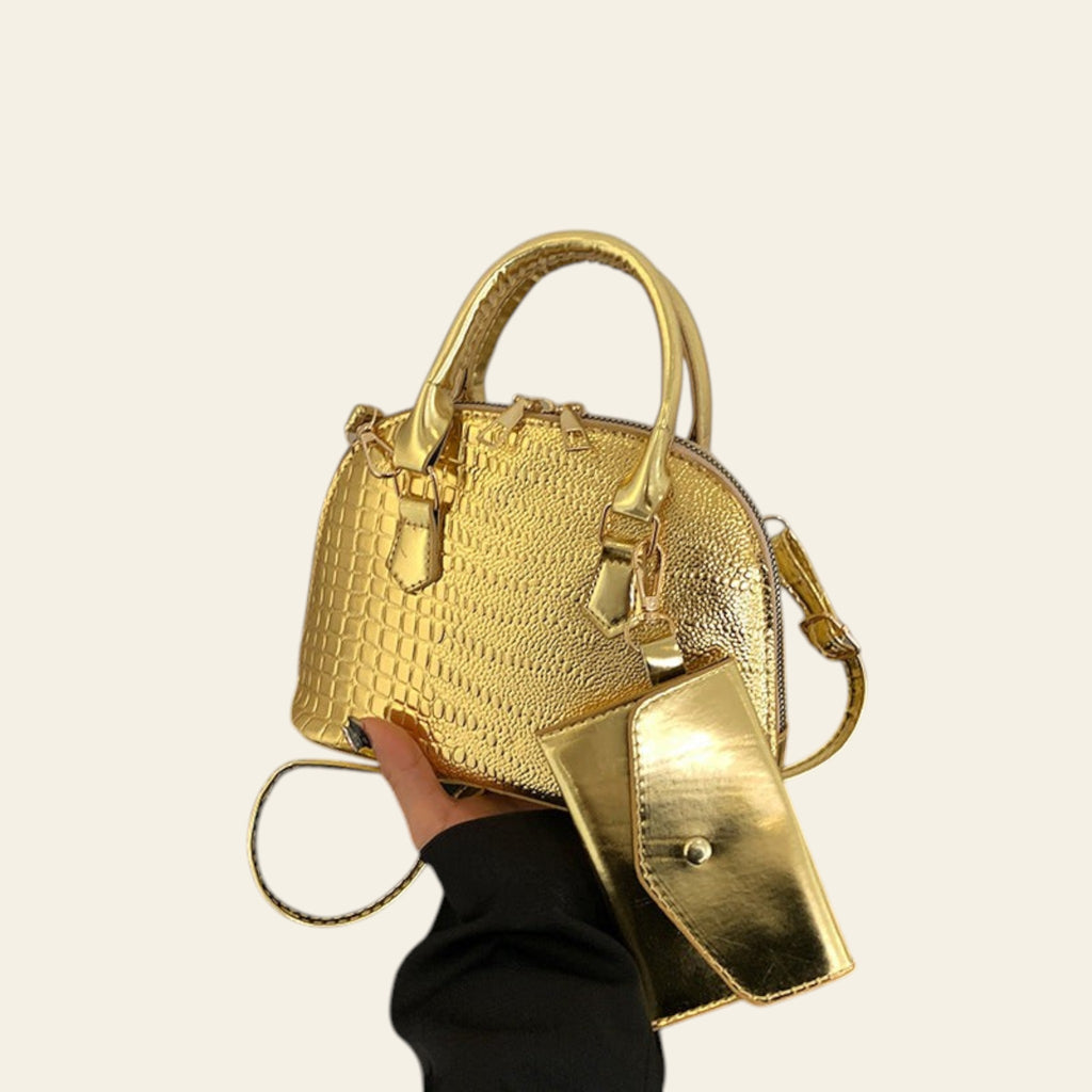 Metallic gold textured leather satchel bag with top handle and crossbody strap