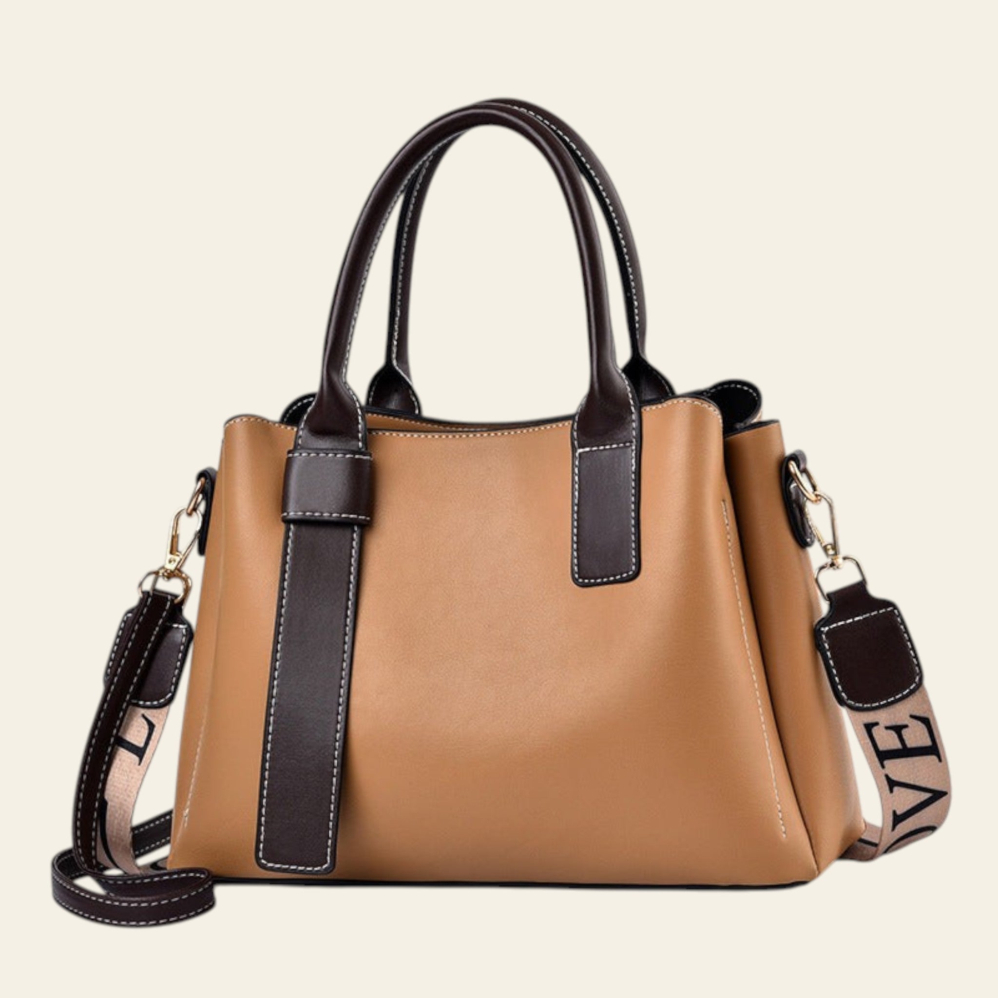 Tan handbag with black accents on a white background