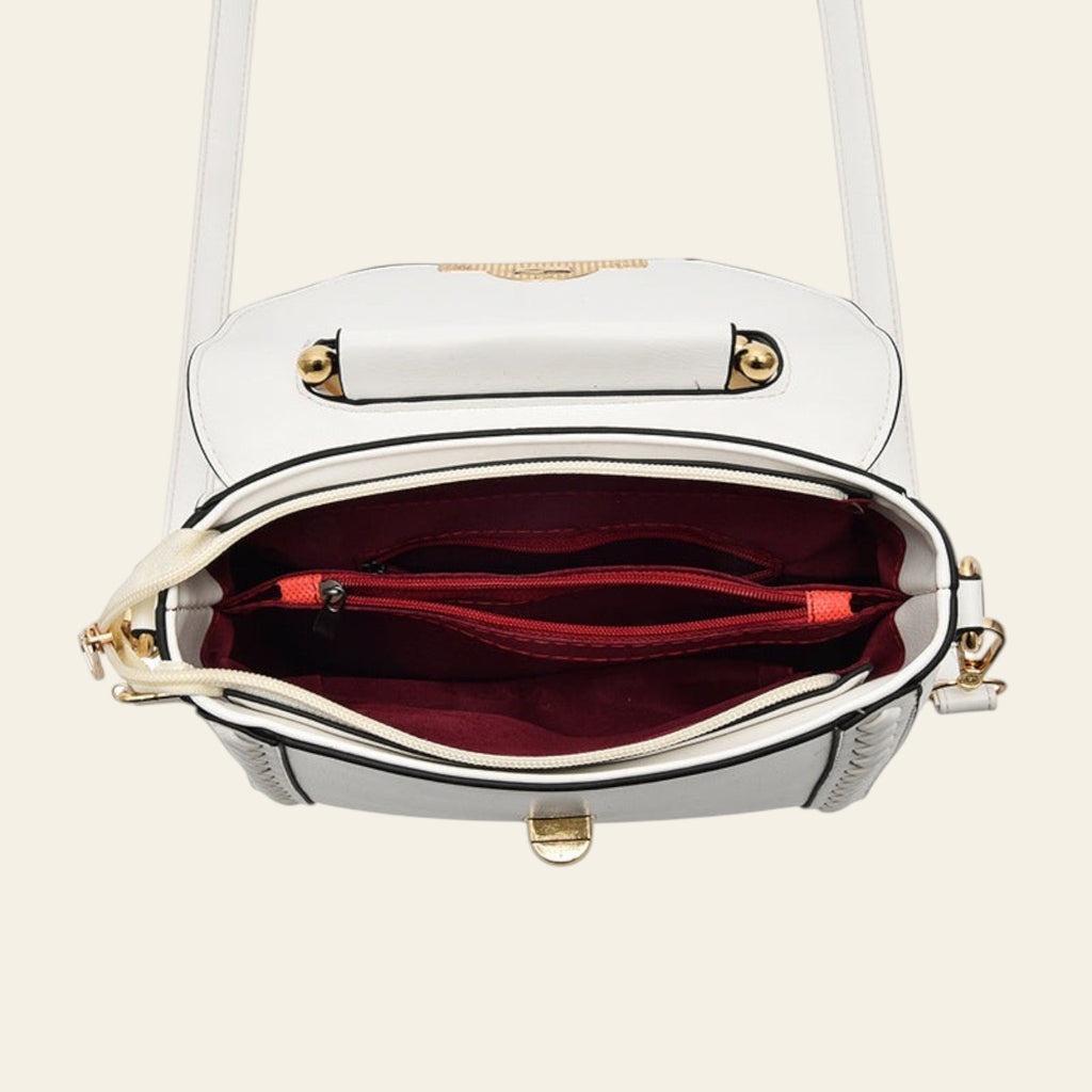 White handbag with gold accents on a white background