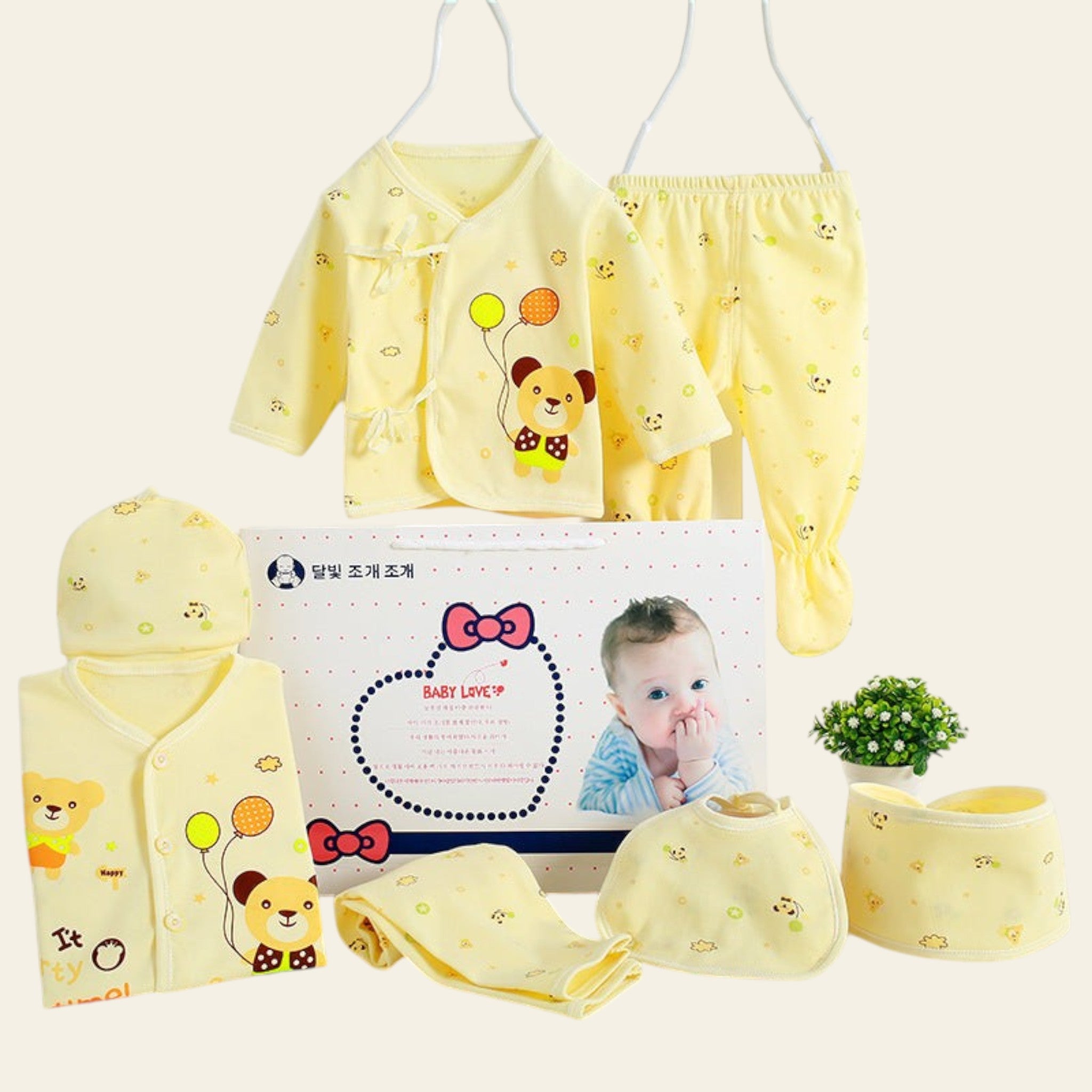 Yellow baby outfit set with matching headband and booties on a white background