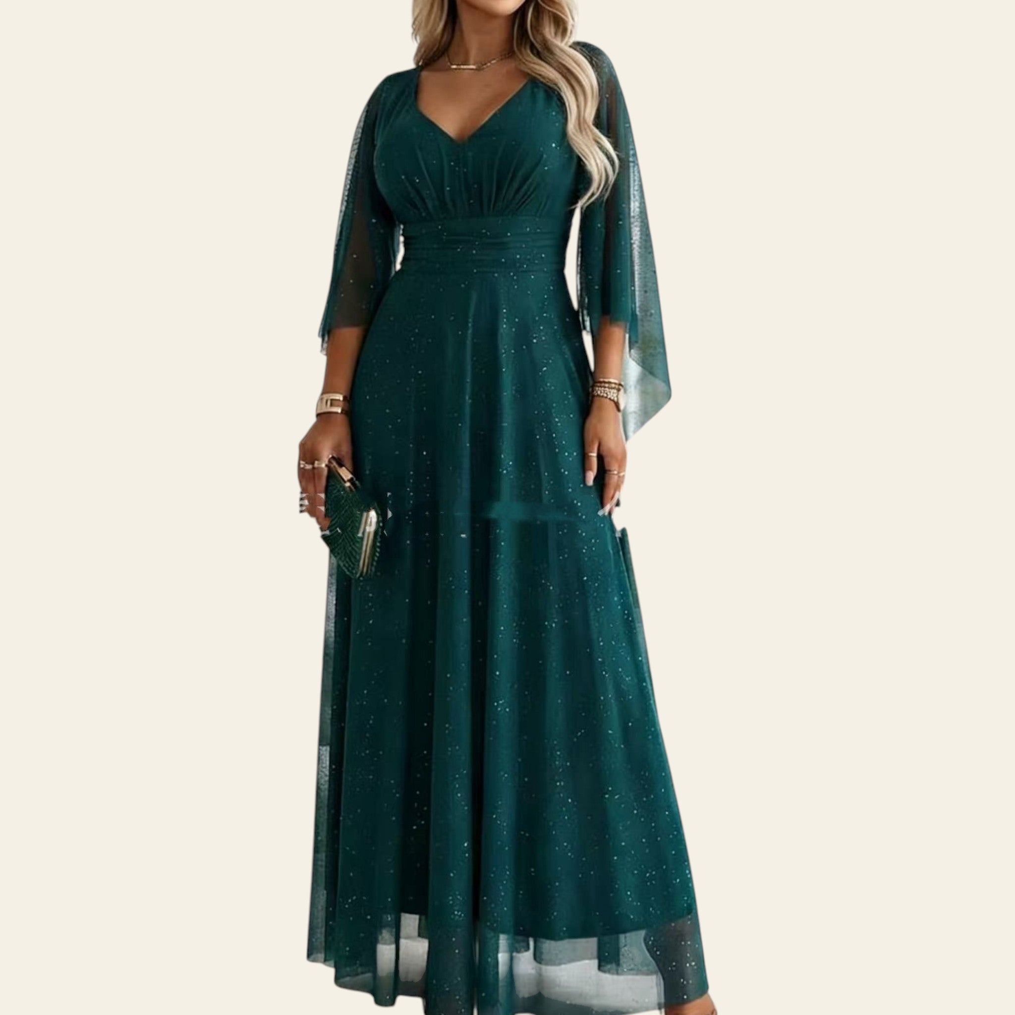 Woman wearing a teal long mesh evening dress with sheer sleeves