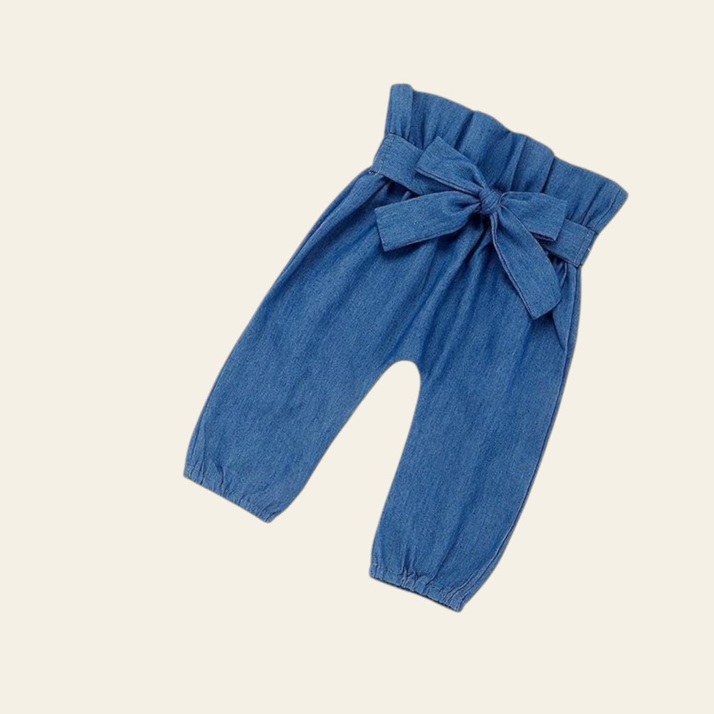 Blue denim baby pants with a bow on a white background