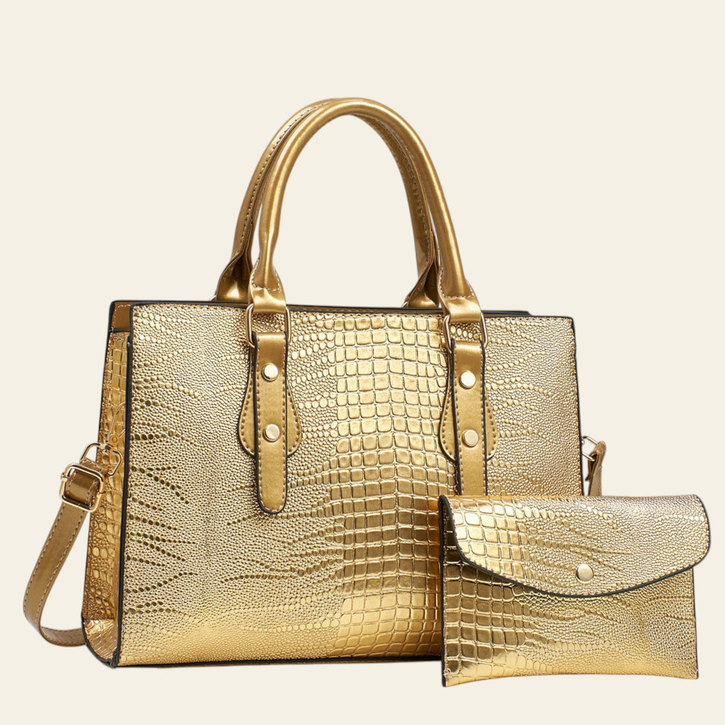 Gold crocodile-patterned handbag with matching pouch on a light gray background
