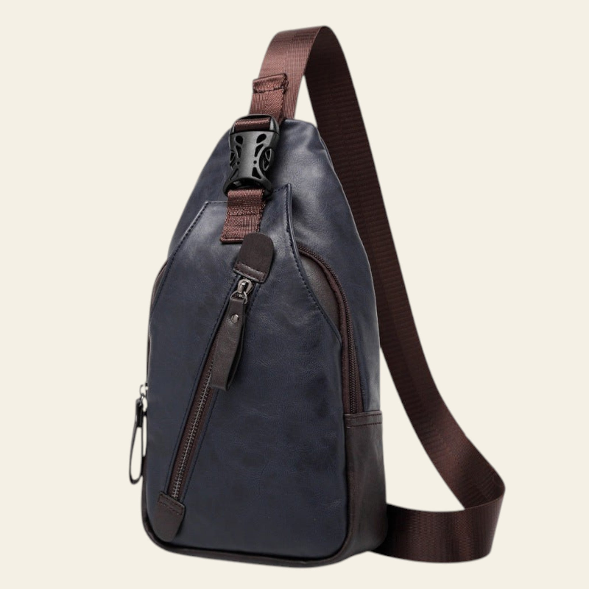Blue sling bag with brown strap on a white background