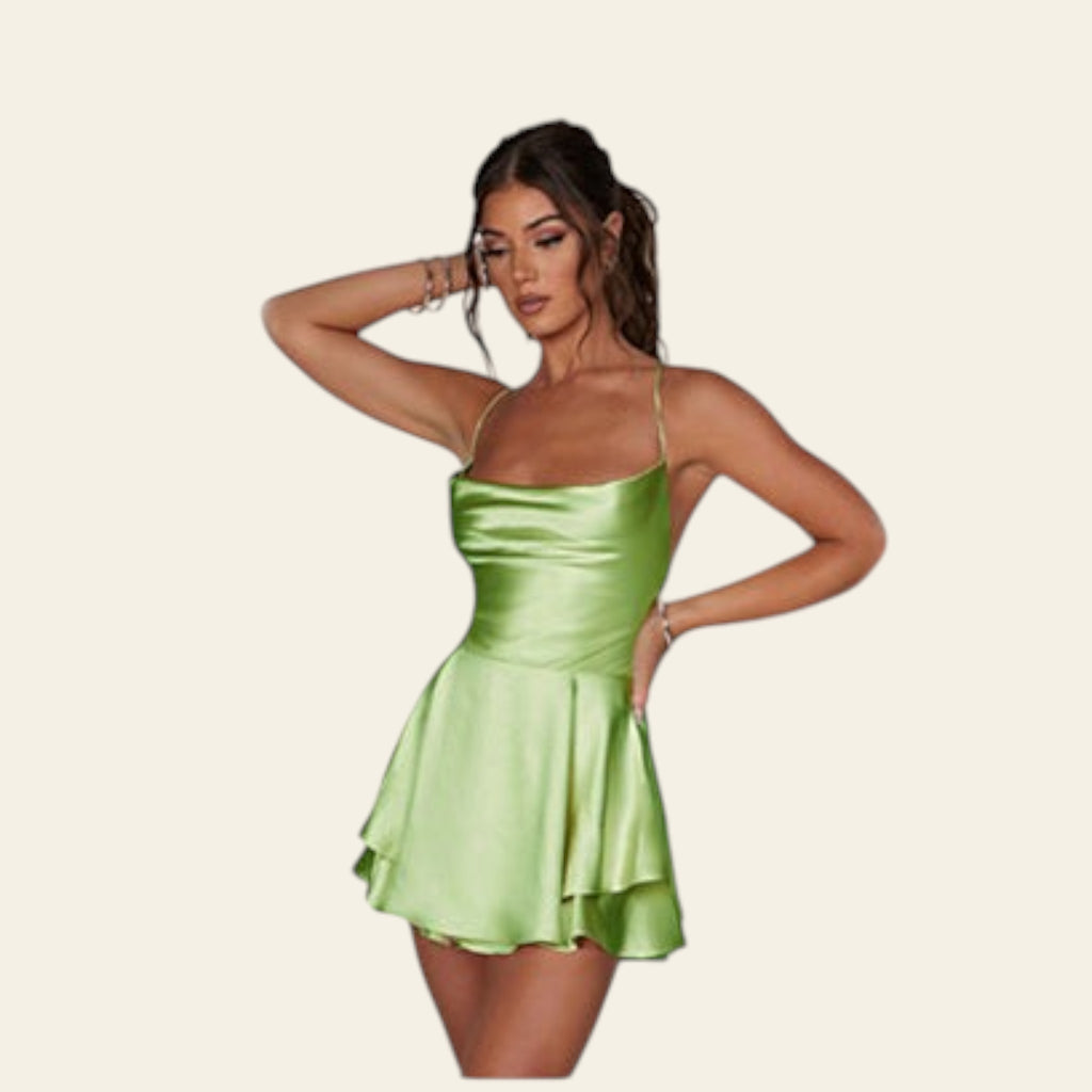 Green satin dress on a person with a diamond bracelet on a white background