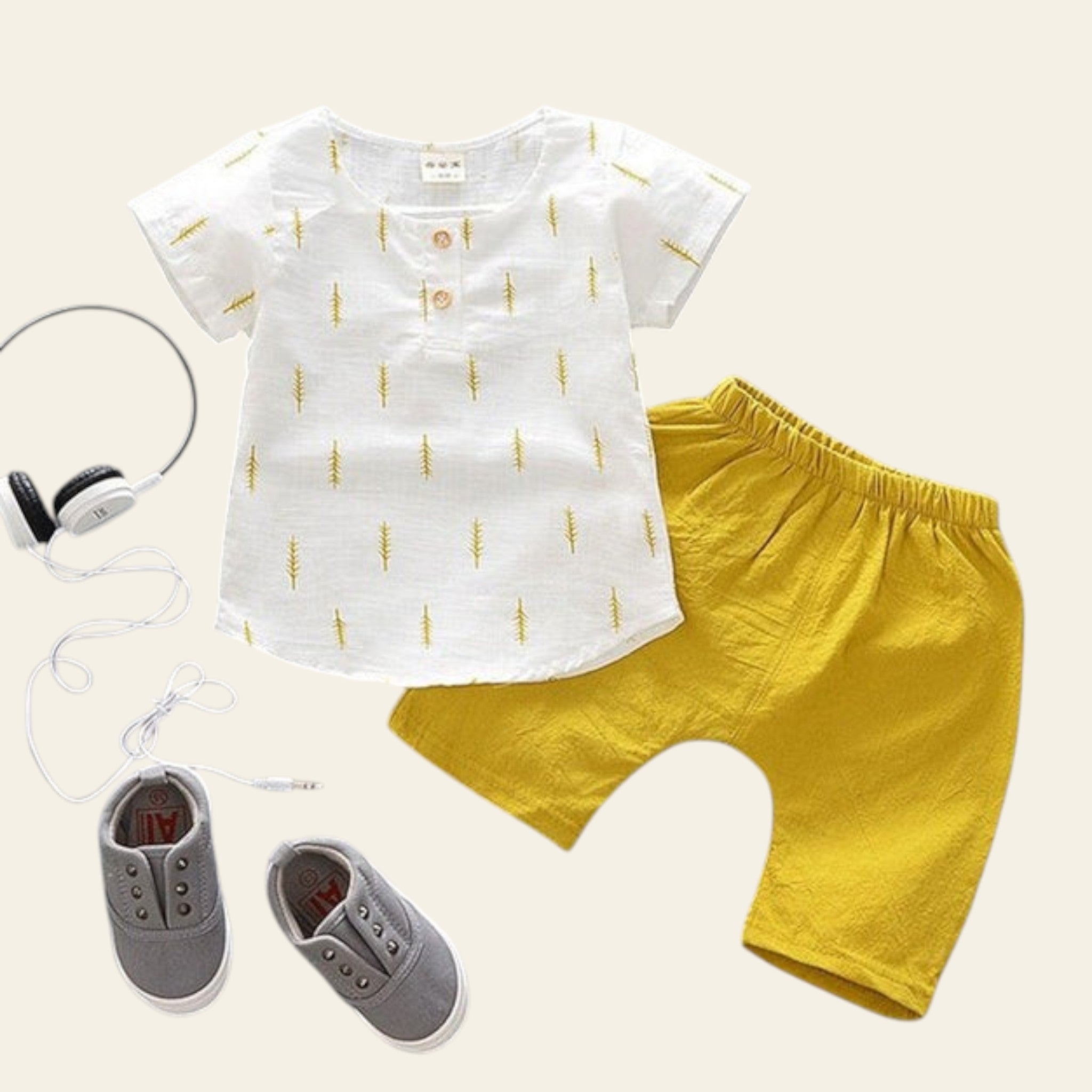 Children's outfit with white shirt and yellow pants on a gray background