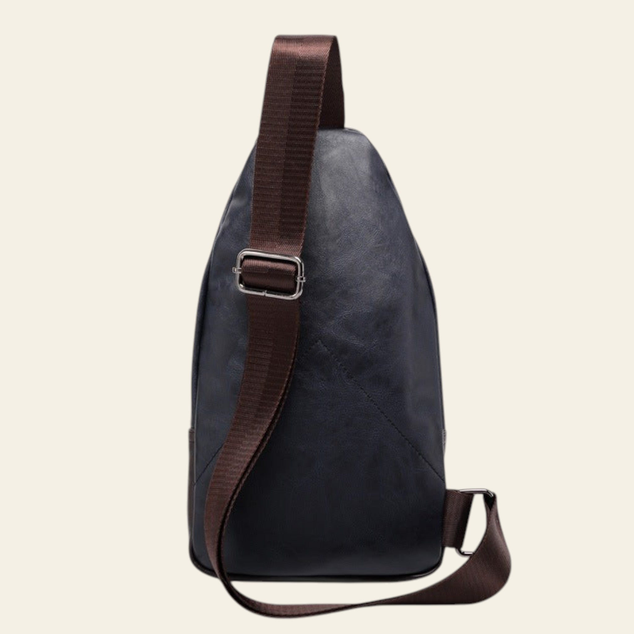 Black sling bag with brown strap on a white background