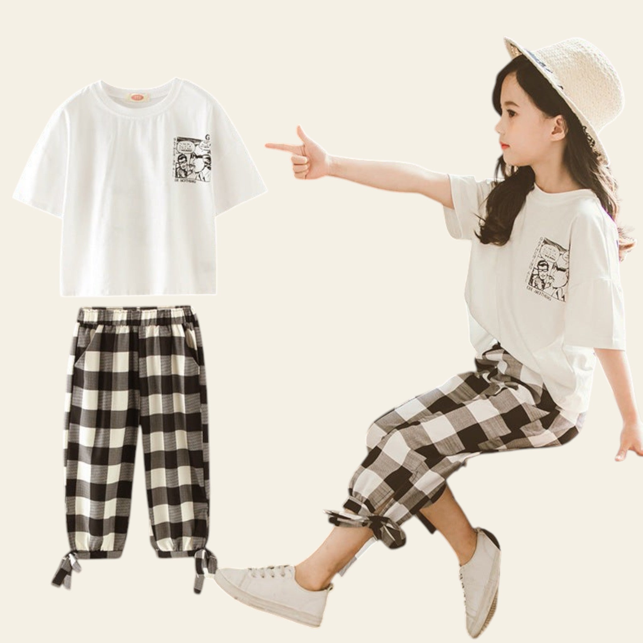 Child wearing a white t-shirt and checkered pants sitting on a stool, pointing at a matching outfit displayed on a mannequin.