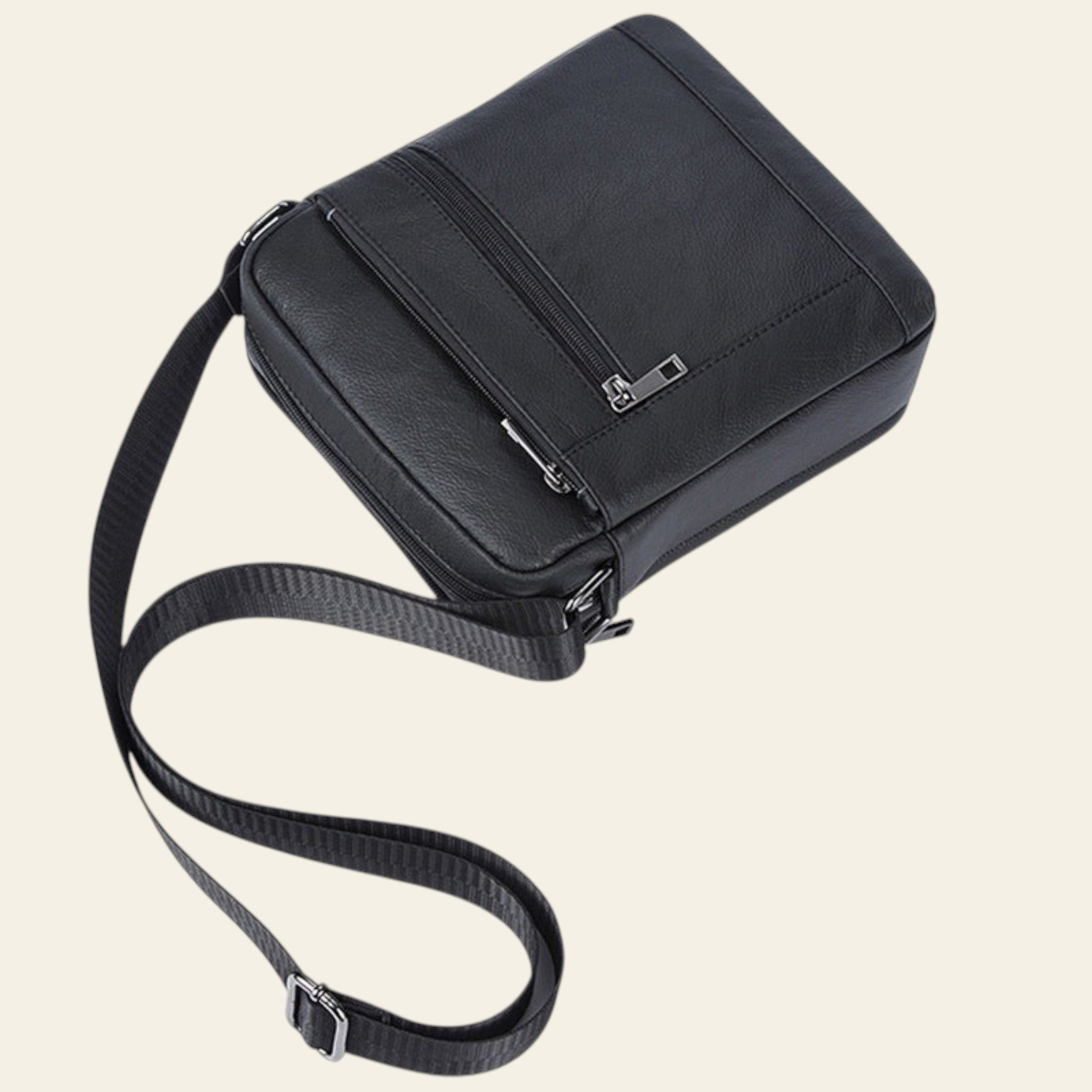 Black shoulder bag with a strap on a white background