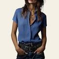 Person wearing a blue shirt with a dark background