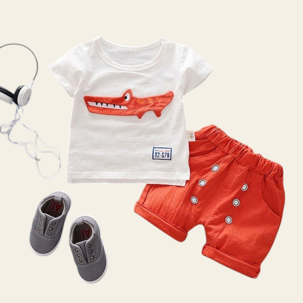 Children's outfit with white t-shirt and red shorts on a gray background