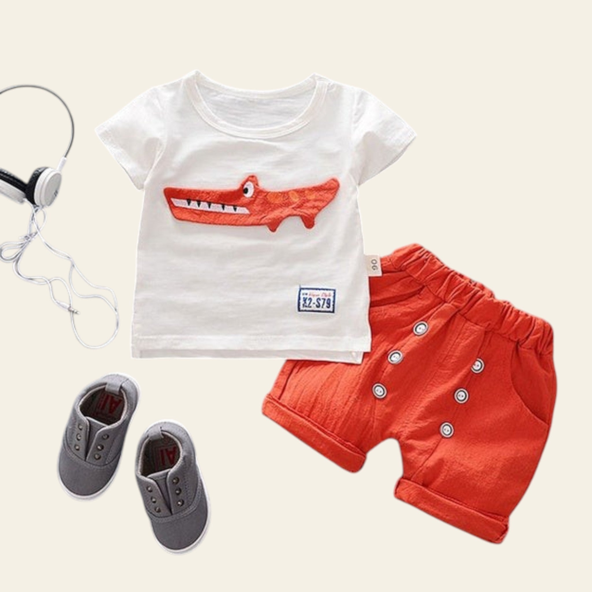 Children's outfit with white t-shirt and red shorts on a gray background