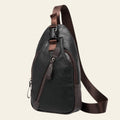 Black leather sling bag with brown accents on a white background
